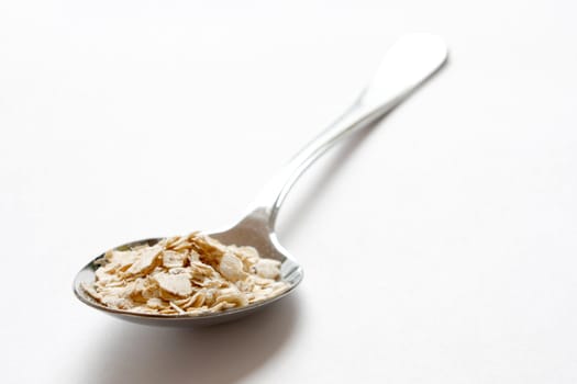 Oats in a heap isolated on white