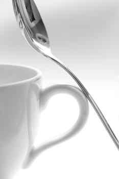 A cup and a spoon on a white background