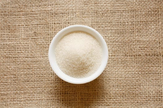 Cane sugar in a bowl on a background