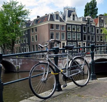 Bicycle parked on a bridge in Amsterdam