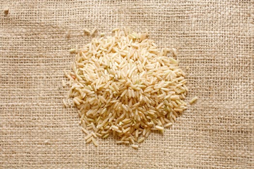 Brown rice on a textile background