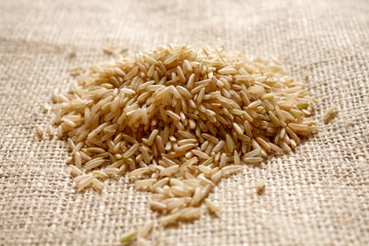 Brown rice on a textile background