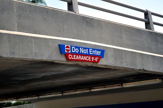 Do not enter, minimum clearance sign on bridge