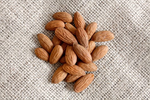 Heap of almonds on a textile bag