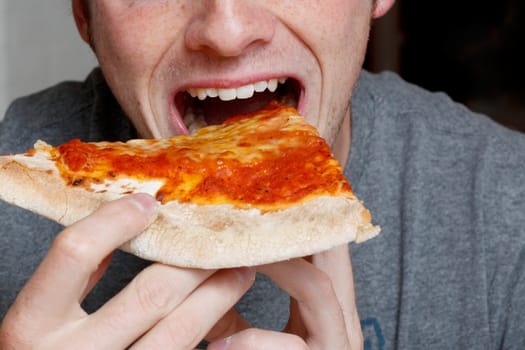 Man eating a pizza slice