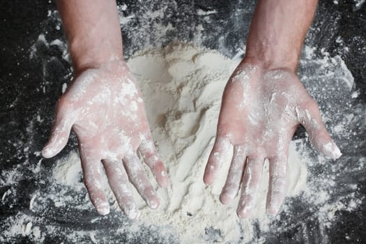 Hands dirty with white flour after preparing