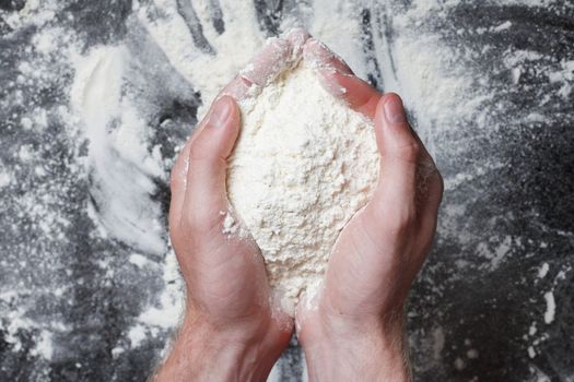 Hands holding white wheat flour