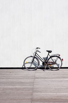 A bike leaning on a wall