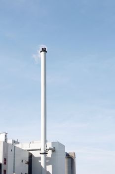 A factory with a tall chimney