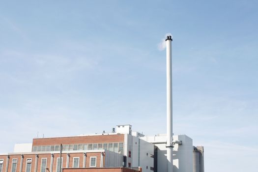 A factory with a tall chimney