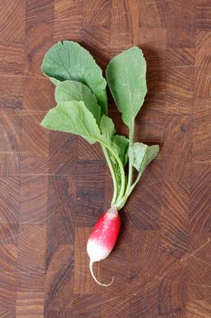 A bunch of radishes on a wooden backgroung