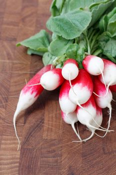 A bunch of radishes on a wooden backgroung