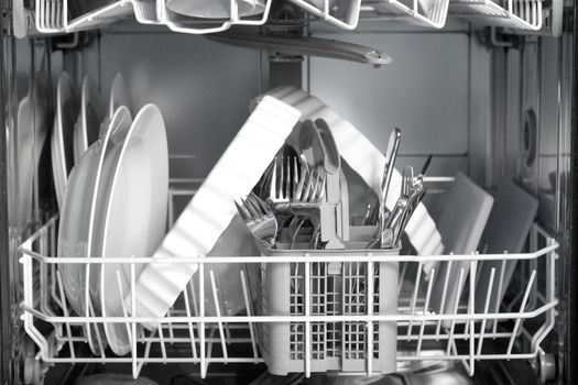 A dishwasher with lots of dishes and glasses