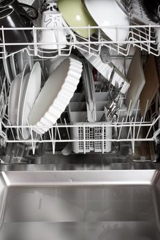 A dishwasher with lots of dishes and glasses