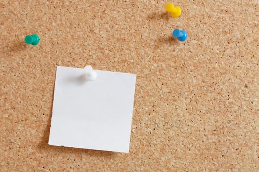 Pins on a wooden notice board