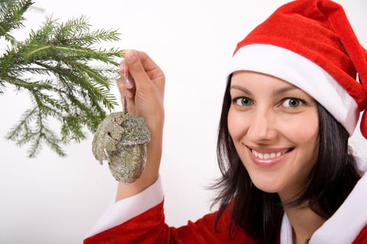 Santa Claus girl hanging toy on christmas tree