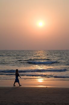 Silhouette of girl over sunset in Goa