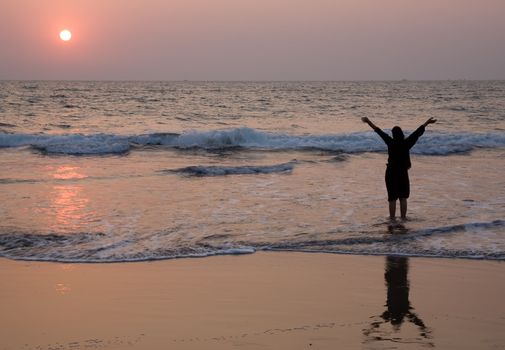 Happy girl have fun on the beach at dusk time