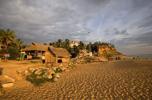 Colorful sunset on the beach in the Kerala over orange sand