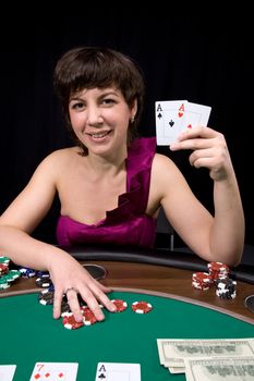Pretty caucasian girl shows two aces in casino poker