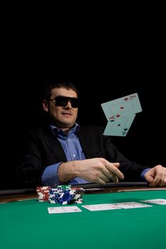 Flying cards in texas hold'em poker over green casino table