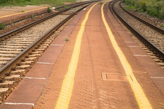 Railway and platform with yellow painted lines.