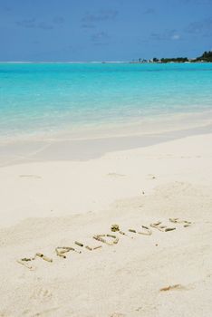 Maldives note written on a white sandy beach