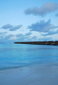 beautiful seascape with water villas in Maldivian Island after sunset