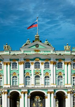 Old European palace with a Russian flag on the steeple