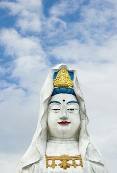Guanyin statue with a white clouds background 