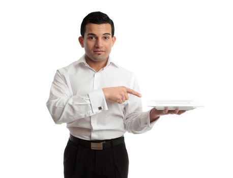 A waiter points to an empty white plate he is holding in his left hand.  White background.