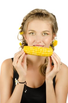 Close-up portrait of young beauty woman eating corn-cob on a white