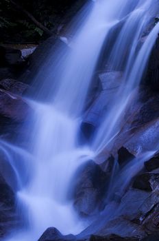 Natural waterfall in tropical rainforest Malaysia in dawn.