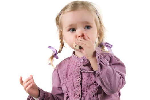 A littlecute  girl eating in studio