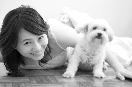 Asian woman playing with her pet, black and white.