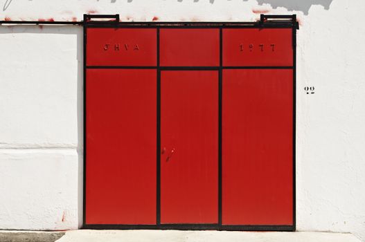 Red sliding gate in a warehouse, Portugal