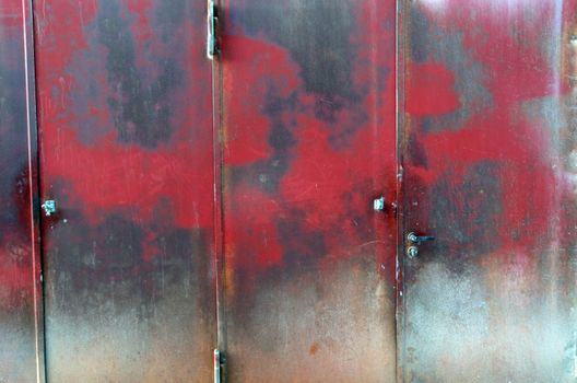 An old industrial steel door with interesting rust pattern