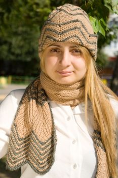 Portrait of the girl with brown scarf and cup
