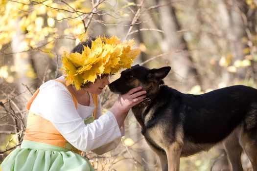 Woman and dog in autumn forest
