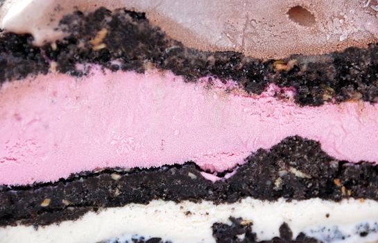 Detail of a strawberry chocolate vanilla ice cream mud pie.
