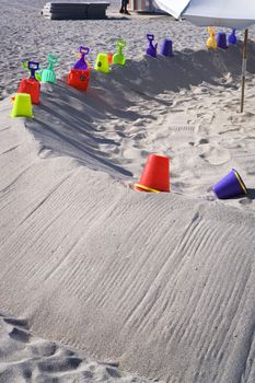 Colorful beach toys lay in the sand for kids to play with on Miami's beautiful South Beach.