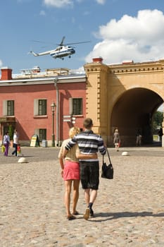 The young couple walks in the Peter and Paul Fortress in St.-Petersburg 
