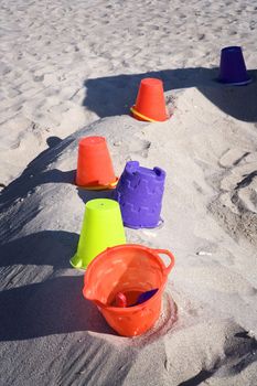 Colorful beach toys lay in the sand for kids to play with on Miami's beautiful South Beach.