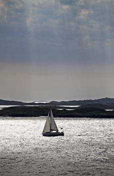 silhouette of a sail boat late in the afternoon