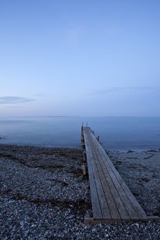 silhouette of a footbridge at the sea