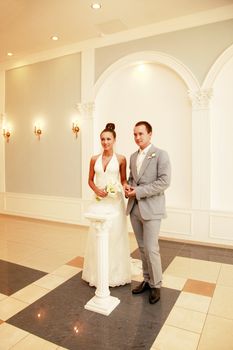 The bride and the groom in a hall of registration of a marriage