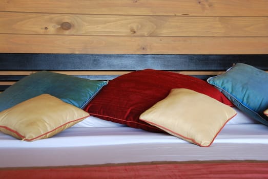 colorful pillows and decoration on a modern hotel bedroom