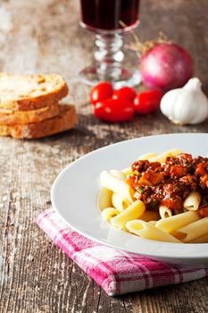 penne bolognese and parmigiano cheese