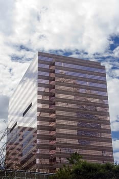 A pink office building with mirrored glass