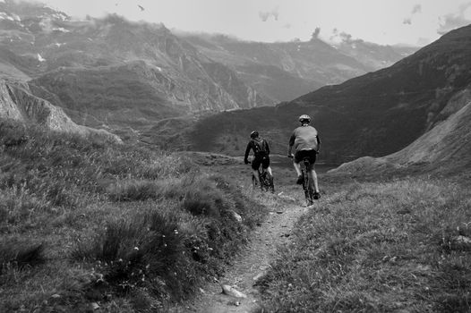 two mountain bikers descending on a trail